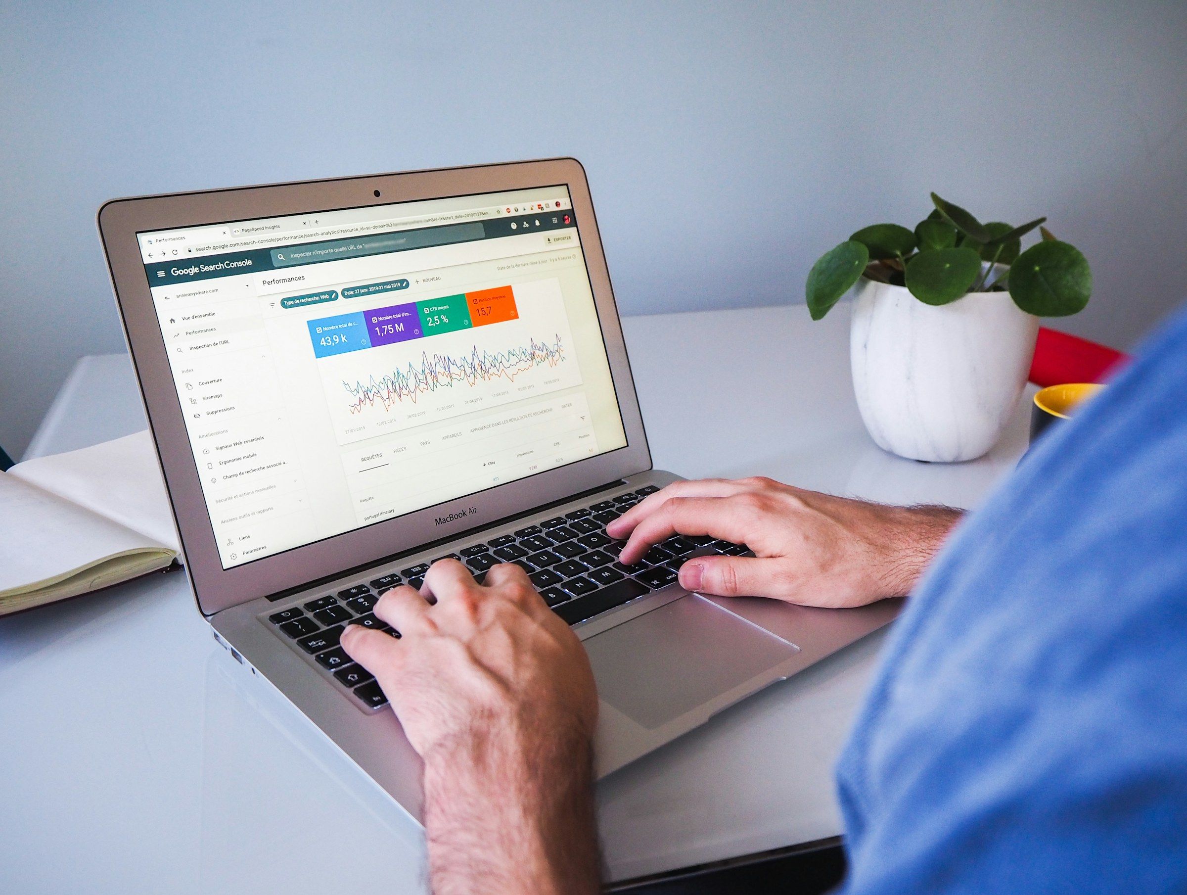 Person working on a laptop showing the Performance report in Google Search Console